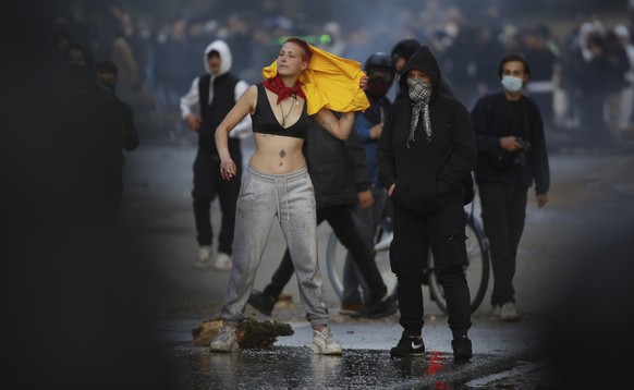 A woman demonstrates at the Bois de la Cambre park during a party called &quot;La Boum 2&quot; in Brussels, Saturday, May 1, 2021. A few thousand people gathered for an illegal party in a Brussels par ...