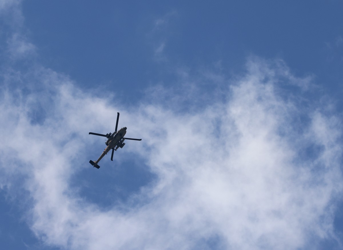 epa11162929 A helicopter flies over the refugee camp in the West Bank city of Tulkarem during a raid carried out by Israeli forces, 18 February 2024. At least three Palestianians were injured during c ...