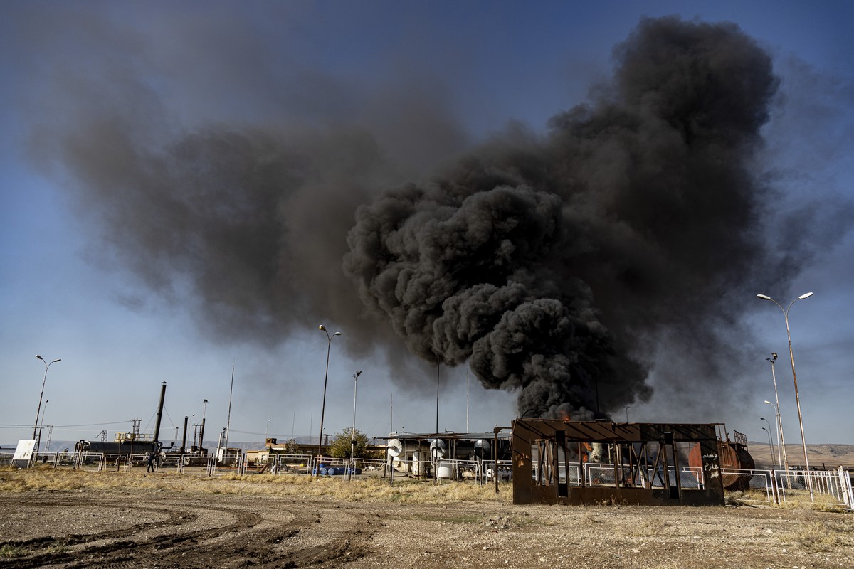 A smoke rises from an oil depot struck by Turkish air force near the town of Qamishli, Syria, Wednesday, Nov. 23, 2022. Turkey's president says he will carry out a land invasion into Kurdish area ...
