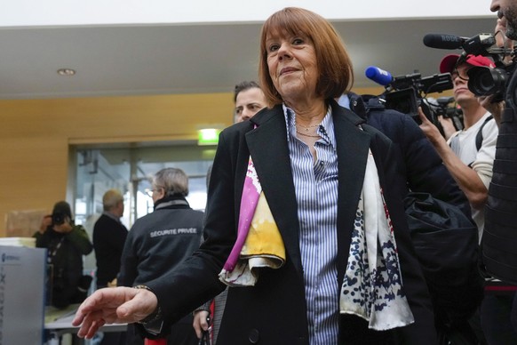 FILE - Gisele Pelicot, who was allegedly drugged by her now former husband so that he and others could assault her, arrives at the court house wearing a scarf printed with artwork of Martu woman, Muly ...