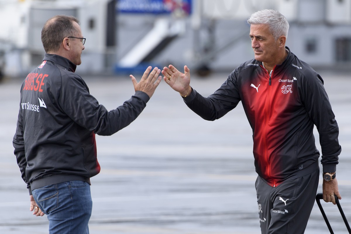 Switzerland's national soccer team head coach Vladimir Petkovic, right, cheers with chief press officer of the Swiss soccer federation Marco Von Ah, left, after getting off the Swiss Internationa ...