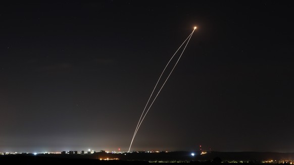 epa07549754 A rocket fired from Gaza is intercepted by an Israeli Iron Dome anti-missile defence system, as seen from Sderot, Israel, 05 May 2019. According to reports, the rockets were fired from Gaz ...