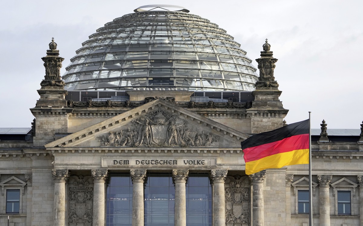 FILE - A national flag of Germany waves in front of the Reichag building, home of the German federal parliament Bundestag, in Berlin, Germany, on Jan. 3, 2022. German lawmakers have approved legislati ...