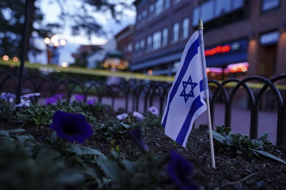 epa12150110 An Israeli flag in a flowerbed near the scene of an incident in Boulder, Colorado, USA, 01 June 2025. Boulder police stated in a press conference that six members of the public have been i ...