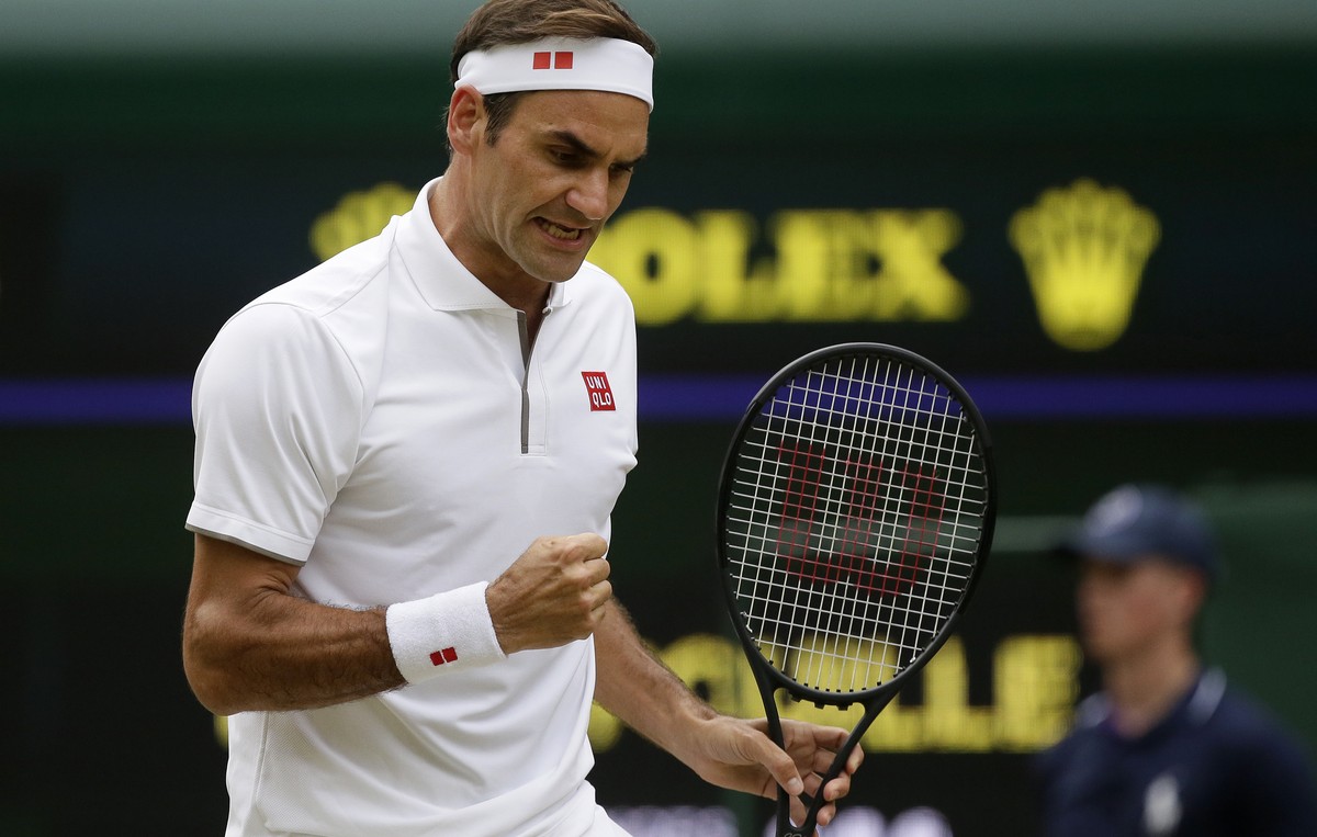 Switzerland's Roger Federer celebrates after winning a point against Lucas Pouile of France in a Men's singles match during day six of the Wimbledon Tennis Championships in London, Saturday, ...