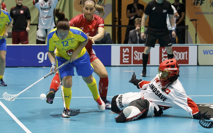 Sweden&#039;s Sofia Joelsson, left, vies for the ball with Switzerland&#039;s Tanja Stella, center, past Switzerland&#039;s goalkeeper Lara Heini, right, during the Gold Medal game of the 12th Women&# ...