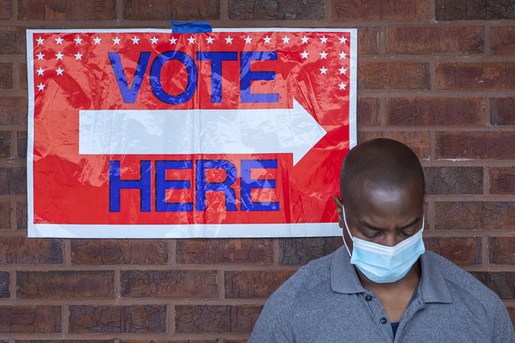 epa08430726 A man wait to cast his ballot as early voting begins for three primaries and elections, at the C.T. Martin Natatorium and Recreation Center in Atlanta, Georgia, USA, 18 May 2020. Three pri ...