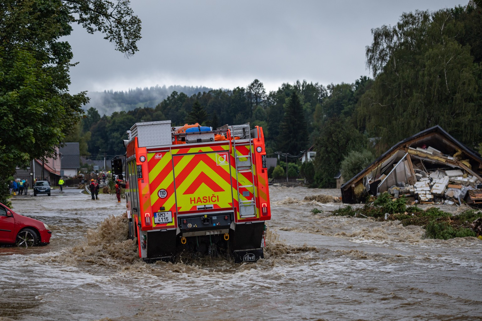 epa11605638 A firefighter vehicle drives through a flooded road caused by the overflowing of the Bela River following heavy rain in the town of Jesenik, Czech Republic, 15 September 2024. Floods cause ...