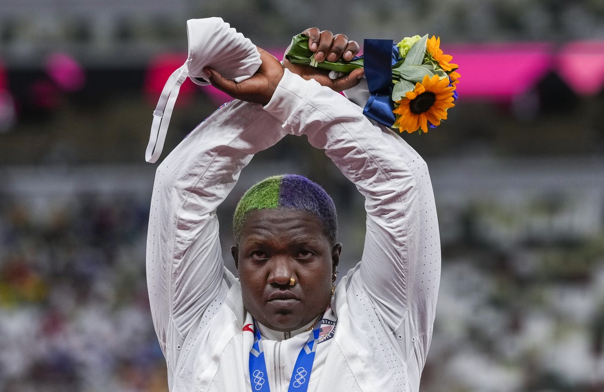 Raven Saunders, of the United States, poses with her silver medal on women's shot put at the 2020 Summer Olympics, Sunday, Aug. 1, 2021, in Tokyo, Japan. During the photo op at her medals ceremon ...