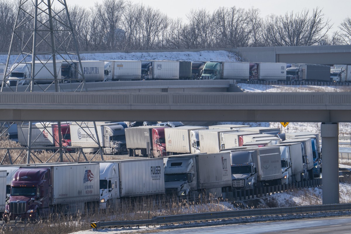 Trucks heading to Canada are stuck in heavy traffic after traffic was diverted to the Blue Water Bridge in Port Huron, Mich., Wednesday, Feb. 9, 2022, after the Ambassador Bridge was closed due to Can ...