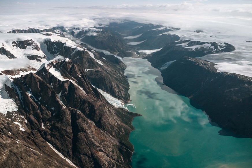 Near the border between Tajikistan and Afghanistan, two rivers merge and flow into the Amu Darya - a major river in Central Asia that ultimately feeds into the Aral Sea. On the Tajikistan side, the tw ...