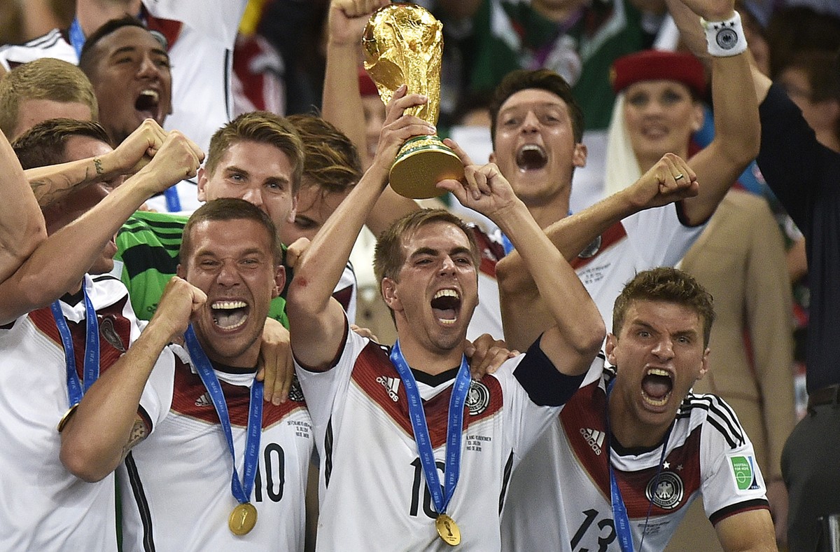 Germany's Philipp Lahm (16) raises the trophy after the World Cup final soccer match between Germany and Argentina at the Maracana Stadium in Rio de Janeiro, Brazil, Sunday, July 13, 2014. German ...