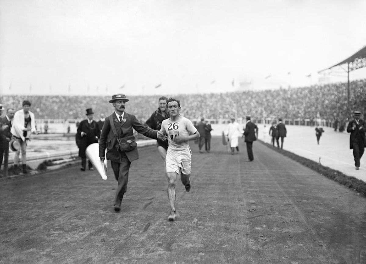 April 6th: On this day in 1896, the first modern Olympics began in Athens. Pictured here is the American athlete Johnny Hayes, who is competing in the marathon race at the 1908 Summer Olympics in Lond ...