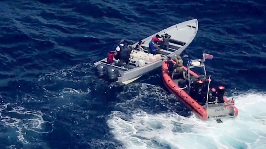 epa07743562 A handout vidoe grab photo made available by the US Coast Guard showing US Coast Guard Cutter Steadfast crew members board a suspected drug smuggling vessel interdicted in international wa ...