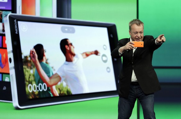 Stepen Elop, executive vice president of Nokia, demonstrates the picture taking ability of the new Nokia Lumia 930 phone during a keynote address of the Microsoft Build Conference Wednesday, April 2,  ...