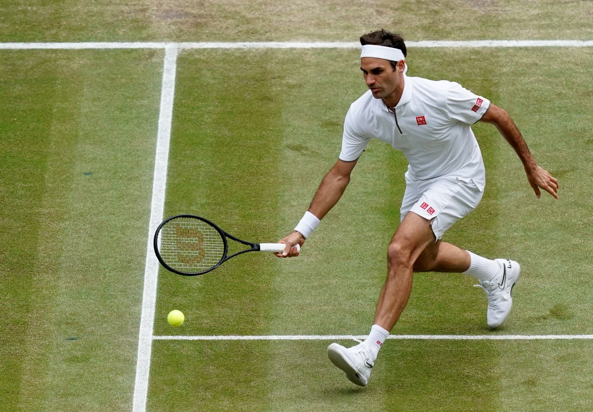 epa07716678 Roger Federer of Switzerland in action against Novak Djokovic of Serbia during their Men's final match for the Wimbledon Championships at the All England Lawn Tennis Club, in London,  ...
