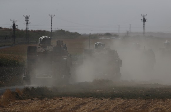 A convoy of Turkish forces&#039; trucks transporting tanks is driven towards the border with Syria in Sanliurfa province, southeastern Turkey, Saturday, Oct. 12, 2019. Turkey says its military offensi ...