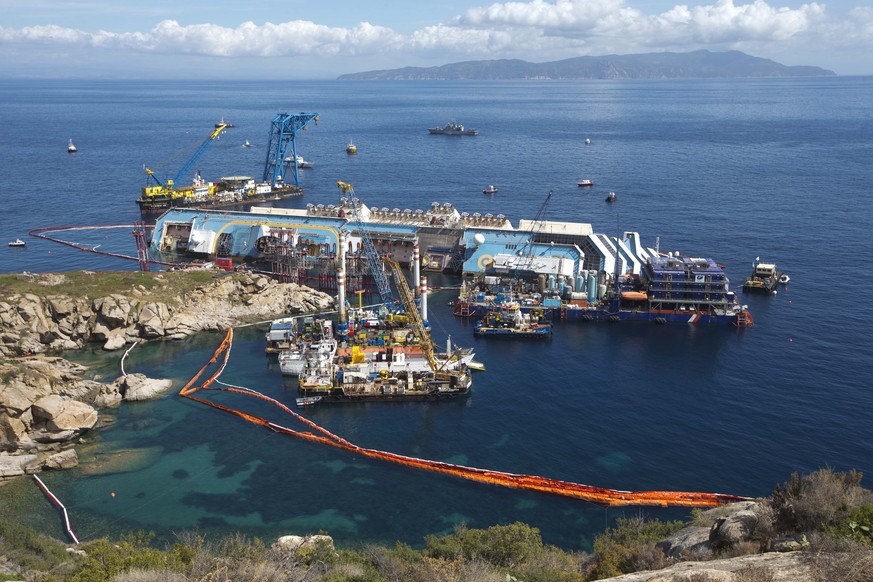 FILE�?? The Costa Concordia ship lies on its side on the Tuscan island of Isola del Giglio, Italy, Monday, Sept. 16, 2013. Italy on Thursday, Jan. 13, 2022, is marking the 10th anniversary of the Conc ...