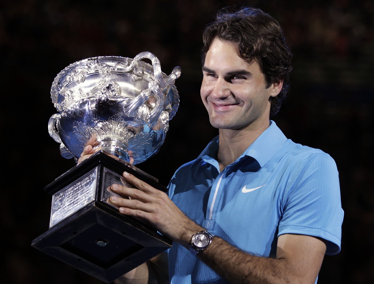 FILE - Roger Federer of Switzerland holds the trophy after beating Andy Murray of Britain to win the Men's singles final match at the Australian Open tennis championship in Melbourne, Australia,  ...
