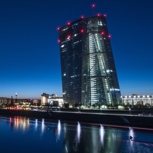 epa04834703 The headquarters of the European Central Bank (ECB) stands out in a late skyline view taken with long exposure late 06 July 2015 in Frankfurt am Main (Hessen), Germany. A light strip from a passing ship and colourful lights illuminate the night atmosphere around the ECB building, which last month froze the ECB's Emergency Liquidity Assistance (ELA) to the Greek central bank at 89 billion euros (80.5 billion dollars), paving the way for the introduction of cash controls in the country. EPA/BORIS ROESSLER