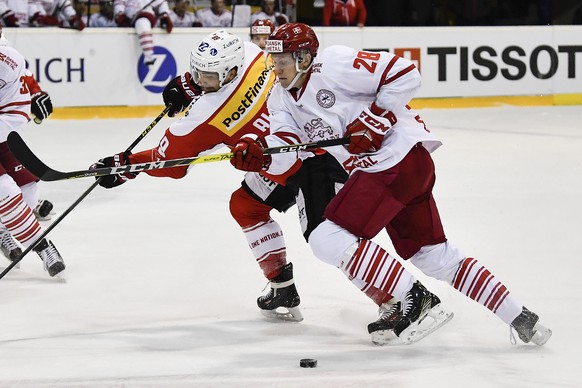 Switzerland’s Cody Almond, left, and Denmark’s Emil Kristensen in action during a friendly ice hockey game between Switzerland and Denmark, at the ice hall in La Chaux-de-Fonds, Switzerland, Wednesday ...