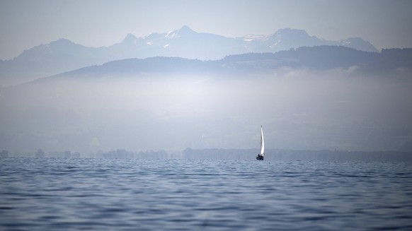A boat sails in front of the Alps over the Lake Constance (Bodensee), southern Germany, Friday, Sept. 13, 2019. (Marijan Murat/dpa via AP)