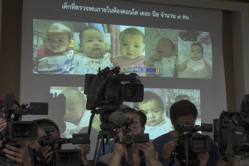 FILE - In this Aug. 12, 2014, file photo, the media attend a press briefing where Thai police display projected pictures of surrogate babies born to a Japanese man who is at the center of a surrogacy  ...