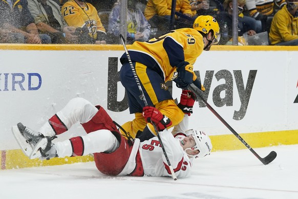 Nashville Predators defenseman Roman Josi (59) and Carolina Hurricanes left wing Warren Foegele (13) collide during the first period in Game 3 of an NHL hockey Stanley Cup first-round playoff series F ...