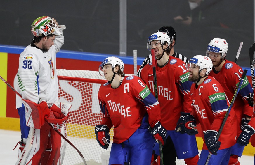 Italy&#039;s goaltender Justin Fazio, left, reacts as Norway&#039;s players celebrate after Norway&#039;s Mathias Trettenes, centre, scored his side&#039;s third goal during the Ice Hockey World Champ ...
