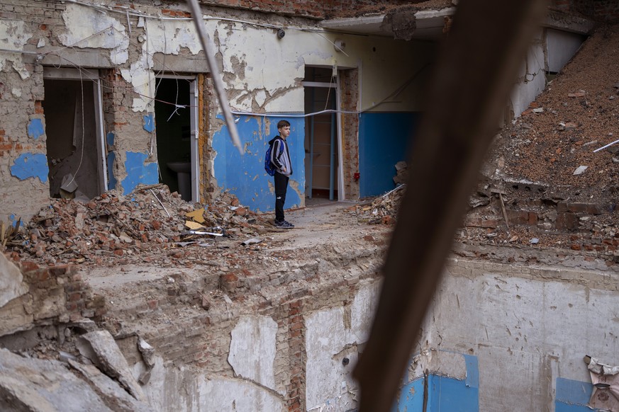 Mykola Kravchenko, 12, looks at his computer class destroyed at Mykhailo-Kotsyubynske&#039;s lyceum, which was bombed by Russian forces on March 4, in Chernihiv, Ukraine, Tuesday, Aug. 30, 2022. &quot ...