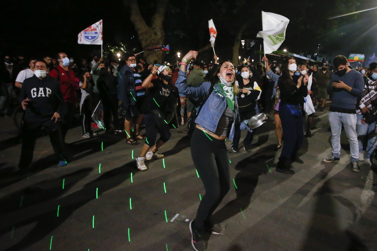People gather at Plaza Italia on the day Chileans voted in a referendum to decide whether the country should replace its 40-year-old constitution, written during the dictatorship of Gen. Augusto Pinoc ...