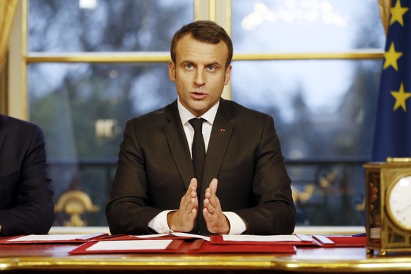 epa06410454 French President Emmanuel Macron delivers a speech next to Spokesperson of the government Benjamin Griveaux (unseen) after he signed three legal texts concerning 2018 State Finances, 2018  ...