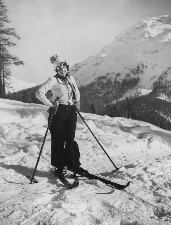 SKIING FASHIONS AT ST. MORITZ. O.P.S. Fraulein Miyam Schaller, the famous Ufa screen star, in an outstanding ski-ing costume of green and white, photographed at St. Moritz, where she is enjoying the w ...