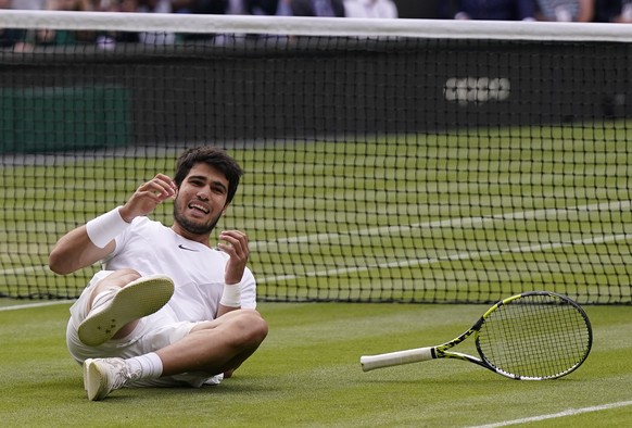 Spain&#039;s Carlos Alcaraz celebrates after beating Serbia&#039;s Novak Djokovic to win the final of the men&#039;s singles on day fourteen of the Wimbledon tennis championships in London, Sunday, Ju ...