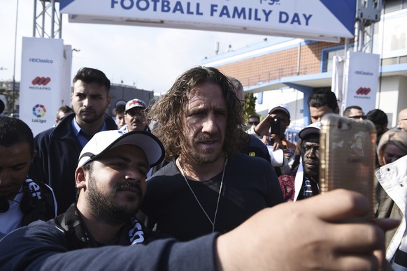 A migrant takes a selfie with retired Spanish soccer player Carles Puyol at the Greek northern city of Thessaloniki, on Sunday, April 23, 2017. About 1000 refugees residing in northern Greece attended ...