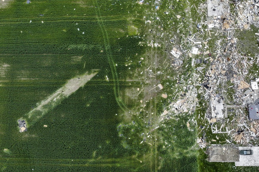 A roof from a damaged home rests in a field at a distance from Fairground Road after a tornado storm system passed through the area the previous night, Tuesday, May 28, 2019, in Celina, Ohio. A rapid- ...