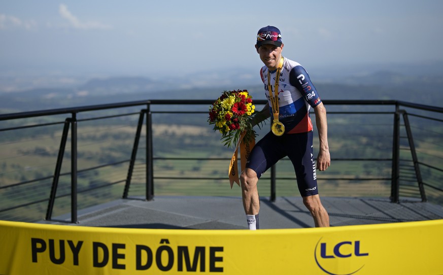 Canada's Michael Woods goes on the podium after winning the ninth stage of the Tour de France cycling race over 182.5 kilometers (113.5 miles) with start in Saint-Leonard-de-Noblat and finish in ...
