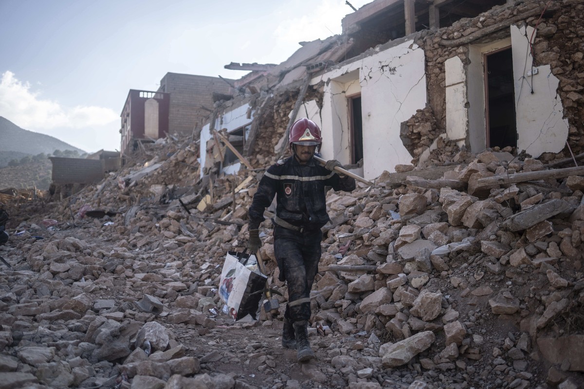 A rescue worker walks through rubble which was caused by the earthquake, in the town of Imi N'tala, outside Marrakech, Morocco, Wednesday, Sept. 13, 2023. An aftershock rattled central Morocco on ...