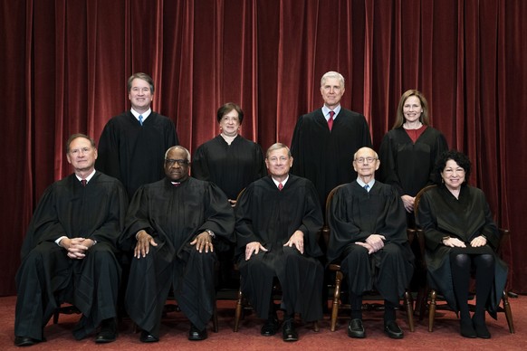 FILE - Members of the Supreme Court pose for a group photo at the Supreme Court in Washington, April 23, 2021. Seated from left are Associate Justice Samuel Alito, Associate Justice Clarence Thomas, C ...