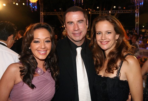In this photo provided by the Scientology Celebrity Centre, Leah Remini, left, John Travolta, center, and Kelly Preston, pose for photographers during the 37th Anniversary Gala at the Church of Scient ...