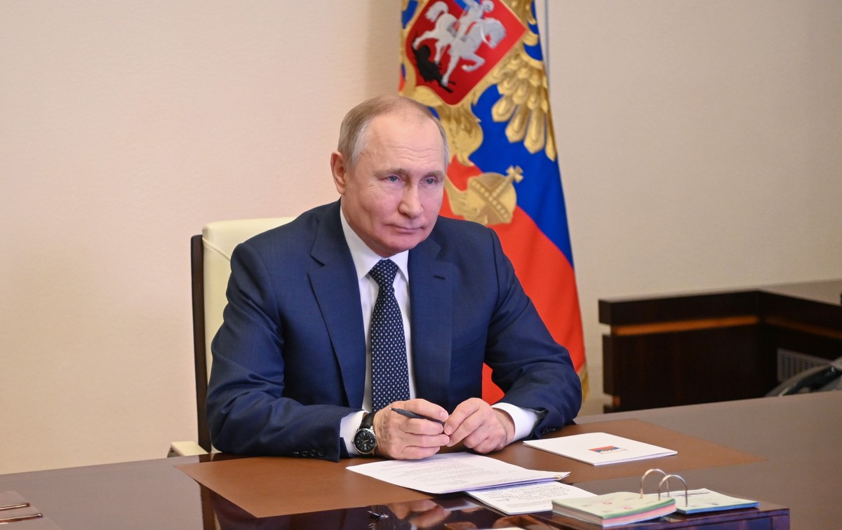 epa09800908 Russian President Vladimir Putin attends a ceremony of raising the national flag on the 'Marshal Rokossovsky' ferry in northern Russia, via a video conference at the Novo-Ogaryov ...