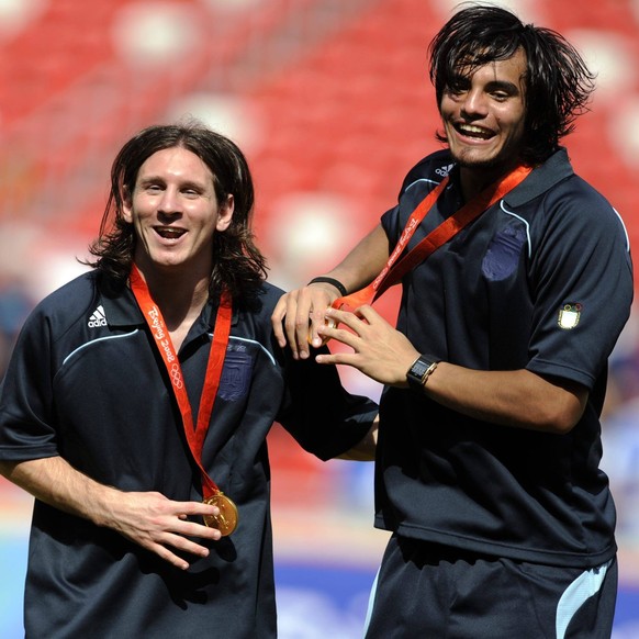 : Argentina s Lionel Messi and Ezequiel Garay R in medal ceremonies of the Olympic Football final Nigeria vs Argentina in the National Stadium Bird s Nest in Beijing, China, on August 23. Argentina wo ...