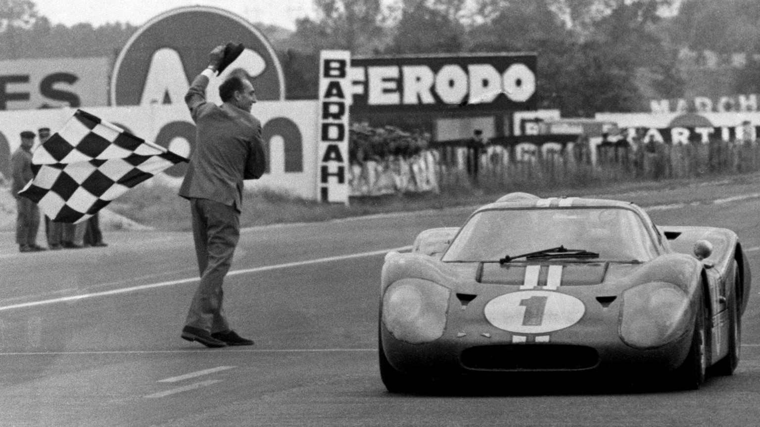 The American Ford, driven by American drivers Dan Gurney and Anthony Joseph Foyt, is seen crossing the finishing line to win the 24-hour endurance race at Le Mans, France, on June 11, 1967. Gurney and ...