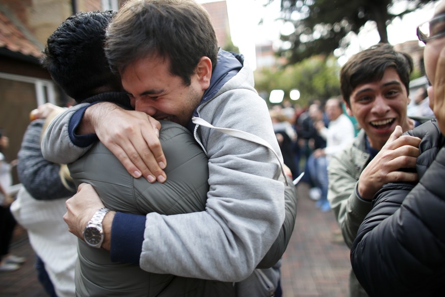 Opponents to the peace deal signed between the Colombian government and rebels of the Revolutionary Armed Forces of Colombia, FARC, celebrate as they listen to the results of the referendum to decide  ...