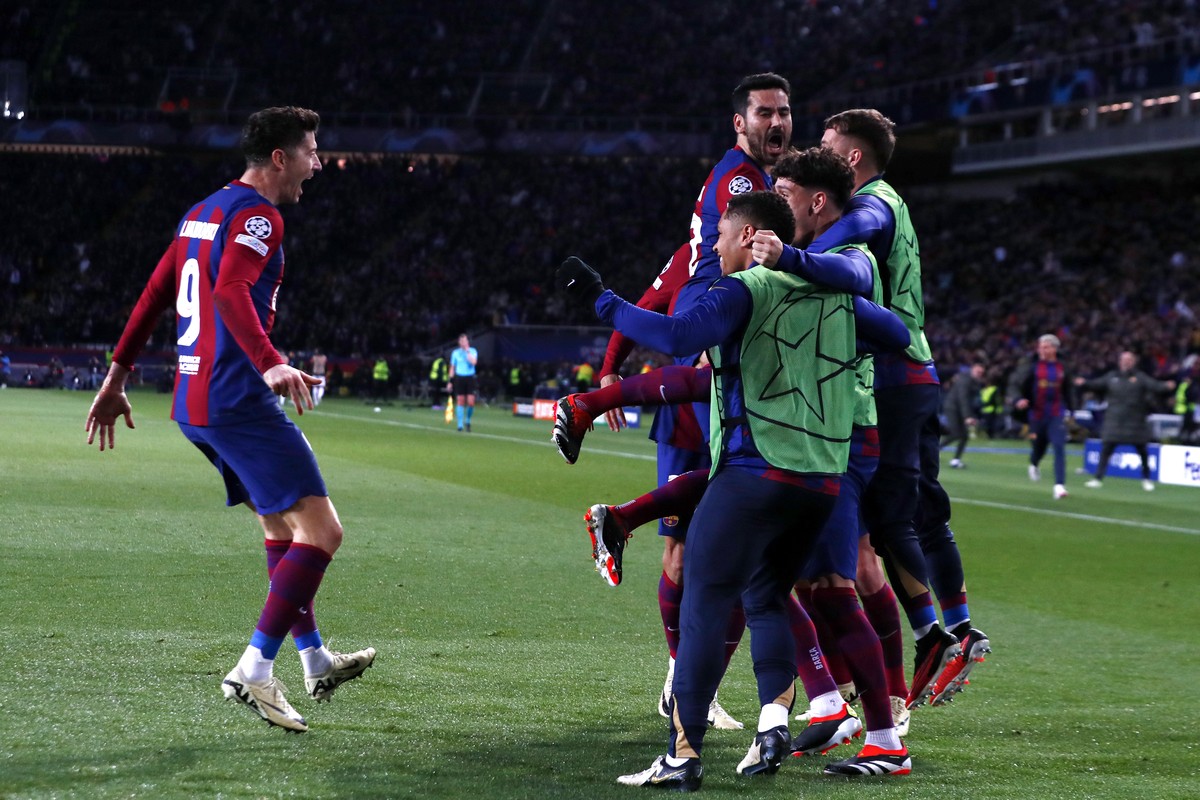Barcelona's Robert Lewandowski, left, celebrates with teammates after scoring his sides third goal during the Champions League, round of 16, second leg soccer match between FC Barcelona and SSC N ...