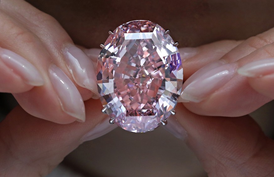 The Pink Star diamond, the most valuable cut diamond ever offered at auction, is displayed by a model at a Sotheby&#039;s auction room in Hong Kong, Wednesday, March 29, 2017. It is the largest intern ...