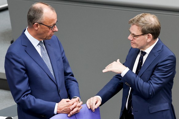 epa12231368 German Chancellor Friedrich Merz (L) and German Foreign Minister Johann Wadephul speak as they attend a plenary session of the German parliament &#039;Bundestag&#039; in Berlin, Germany, 1 ...