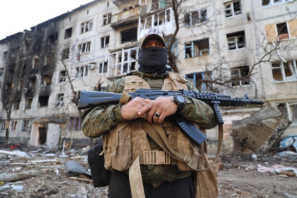 Ukraine: Situation in Artyomovsk UKRAINE, DONETSK REGION - MARCH 24, 2023: A Wagner Group soldier guards an area outside an apartment block in the city of Artyomovsk Bakhmut damaged in a shelling atta ...
