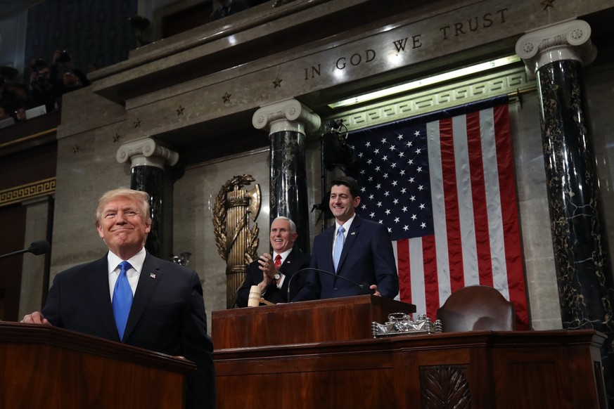 epa06486866 US President Donald J. Trump (L) stands at the podium as US Vice President Mike Pence (C) and Speaker of the US House of Representatives Paul Ryan (R) look on during the State of the Union ...