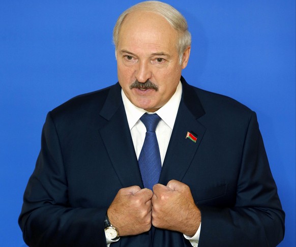 FILE - In this Sunday, Oct. 11, 2015, file photo Belarusian President Alexander Lukashenko speaks to the media at a polling station after voting during the presidential election in Minsk, Belarus. Bel ...